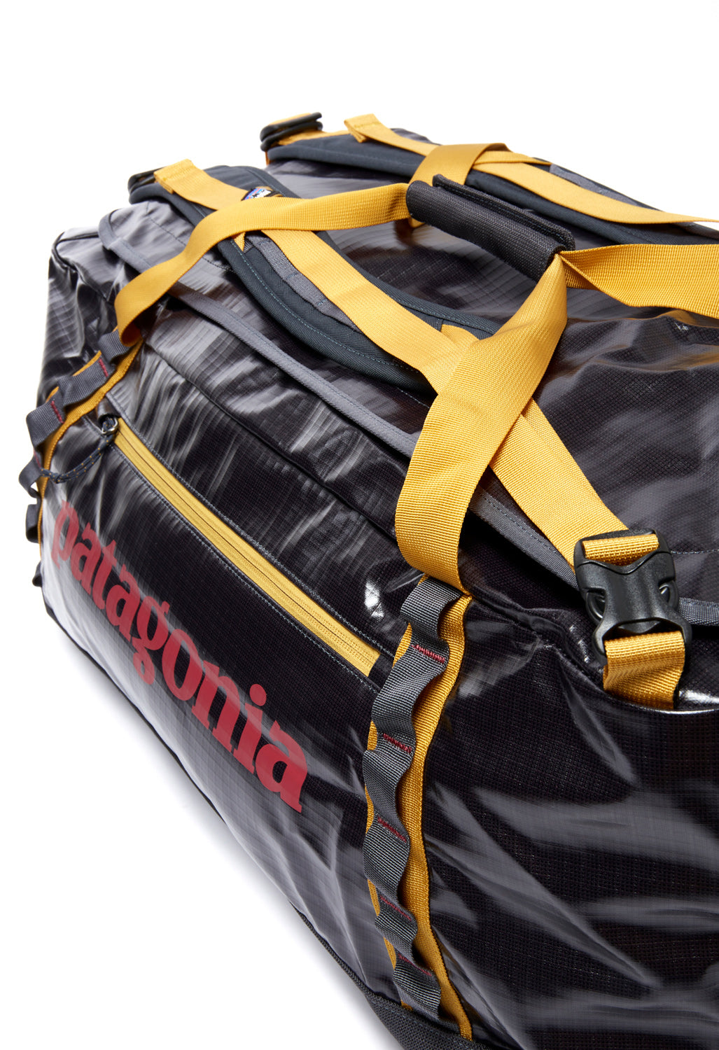 hammonds gold patagonia black hole Hole Mini MLC 30L Worn Wear webbing handles with a snap closure and haul loops at either end that facilitate linking multiple bags Patagonia Black Hole Duffel 70L
