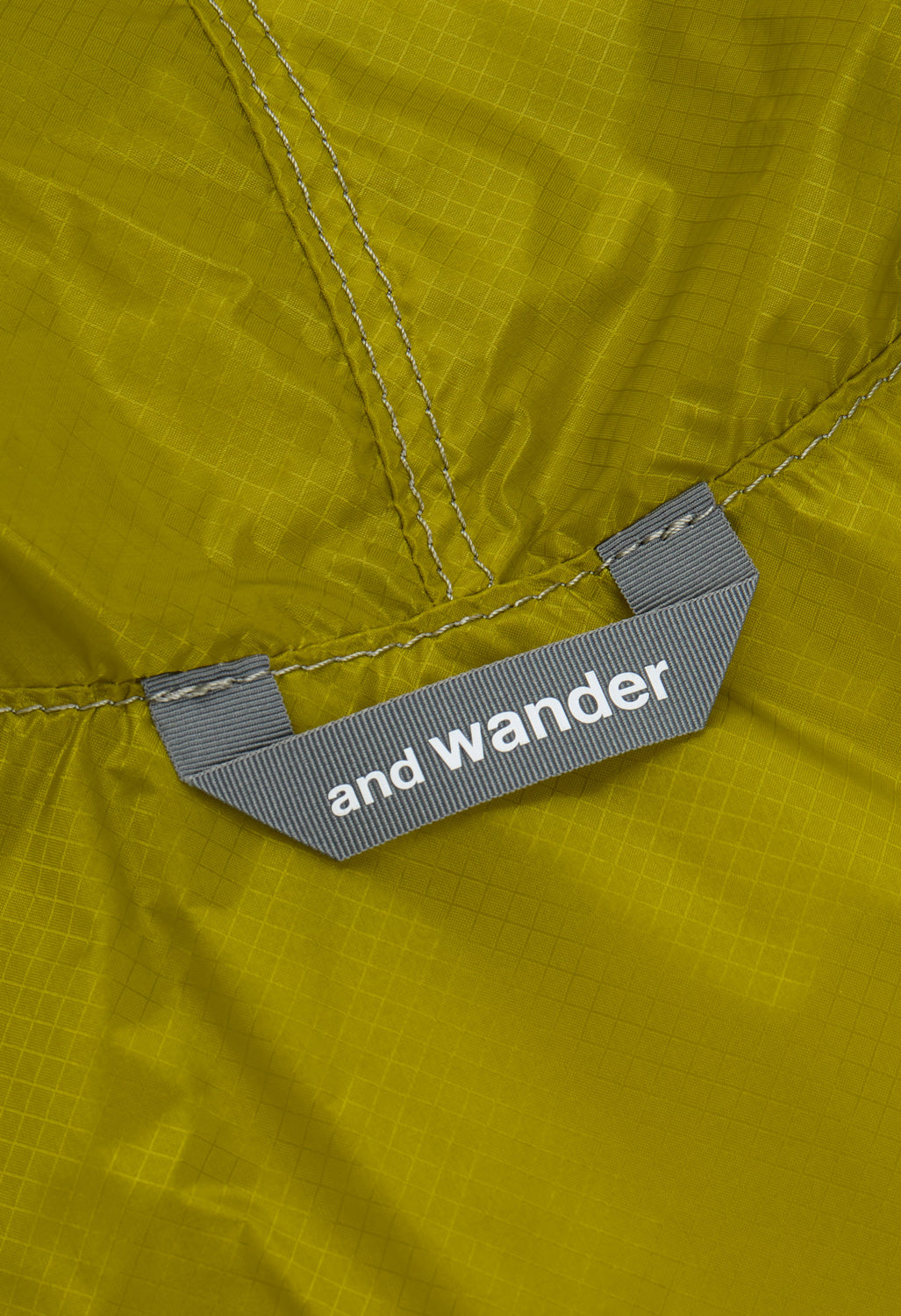 and wander x Brompton Sil Poncho - Yellow Green